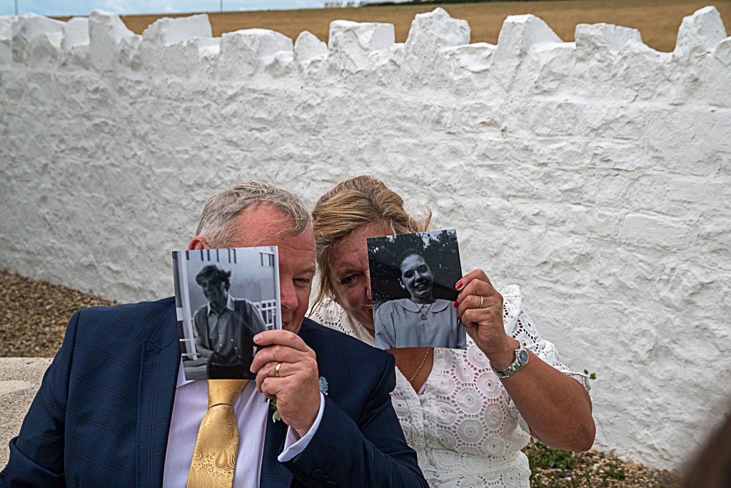 lisa & roland hide behind photos of their younger selves