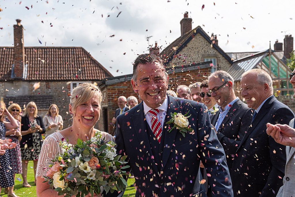 pamela & philip are showered in confetti